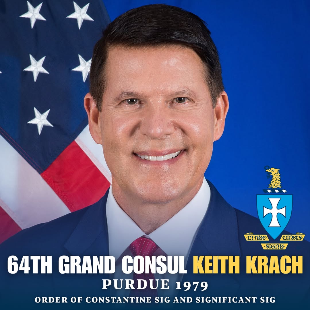 The image shows Keith Krach, an American businessman, former U.S. Under Secretary of State, and the 64th Grand Consul of the Sigma Chi fraternity.